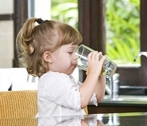 Girl drinking Clean Haferman Water from glass