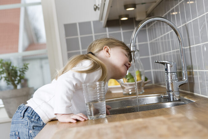 Well Water Filtration - Child Drinking from faucet